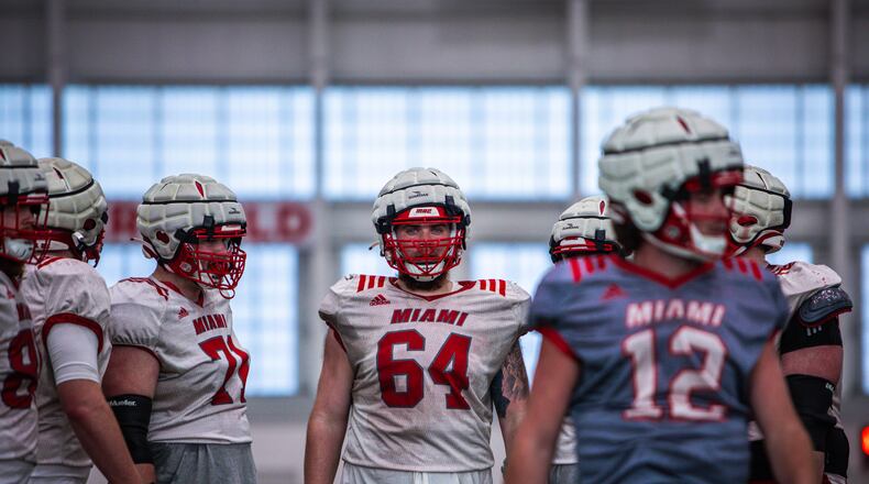 Miami center Kolby Borders (64) and teammates go through a recent spring practice in Oxford. Miami University Athletics photo