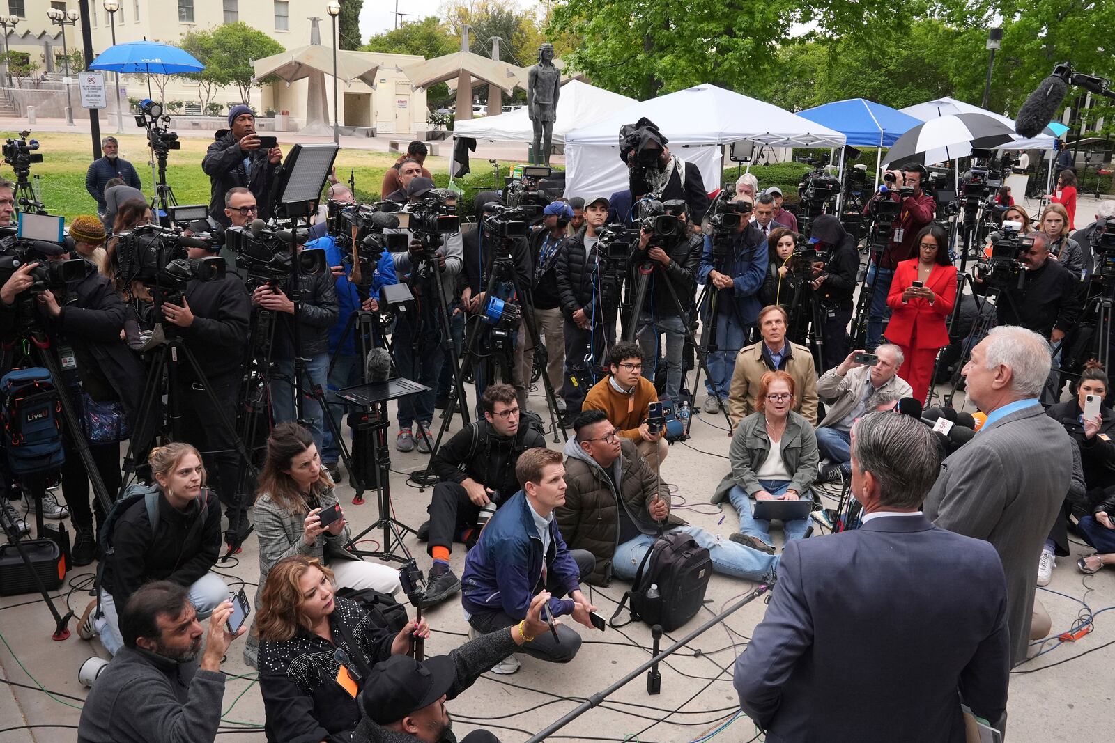 Attorney Mark Geragos, right, representing Erik and Lyle Menendez, who were sentenced in 1996 to life in prison without the possibility of parole for fatally shooting their parents, speaks to the media outside of court after a resentencing hearing in their case, Thursday, April 17, 2025, in Los Angeles. (AP Photo/Damian Dovarganes)