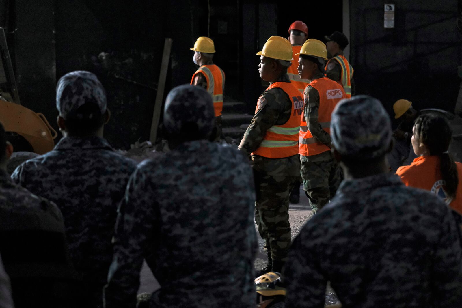 Rescue workers stand by as they take turns searching for survivors at the Jet Set nightclub after its roof collapsed two nights ago during a merengue concert in Santo Domingo, Dominican Republic, Wednesday, April 9, 2025. (AP Photo/Ricardo Hernandez)