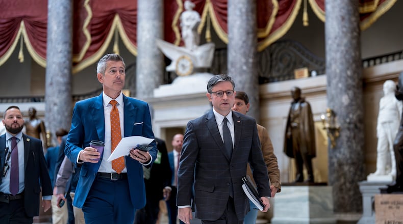 Transportation Secretary Sean Duffy, left, and Speaker of the House Mike Johnson, R-La., walk through Statuary Hall at the Capitol to a news conference on day 23 of the government shutdown, in Washington, Thursday, Oct. 23, 2025. (AP Photo/J. Scott Applewhite)