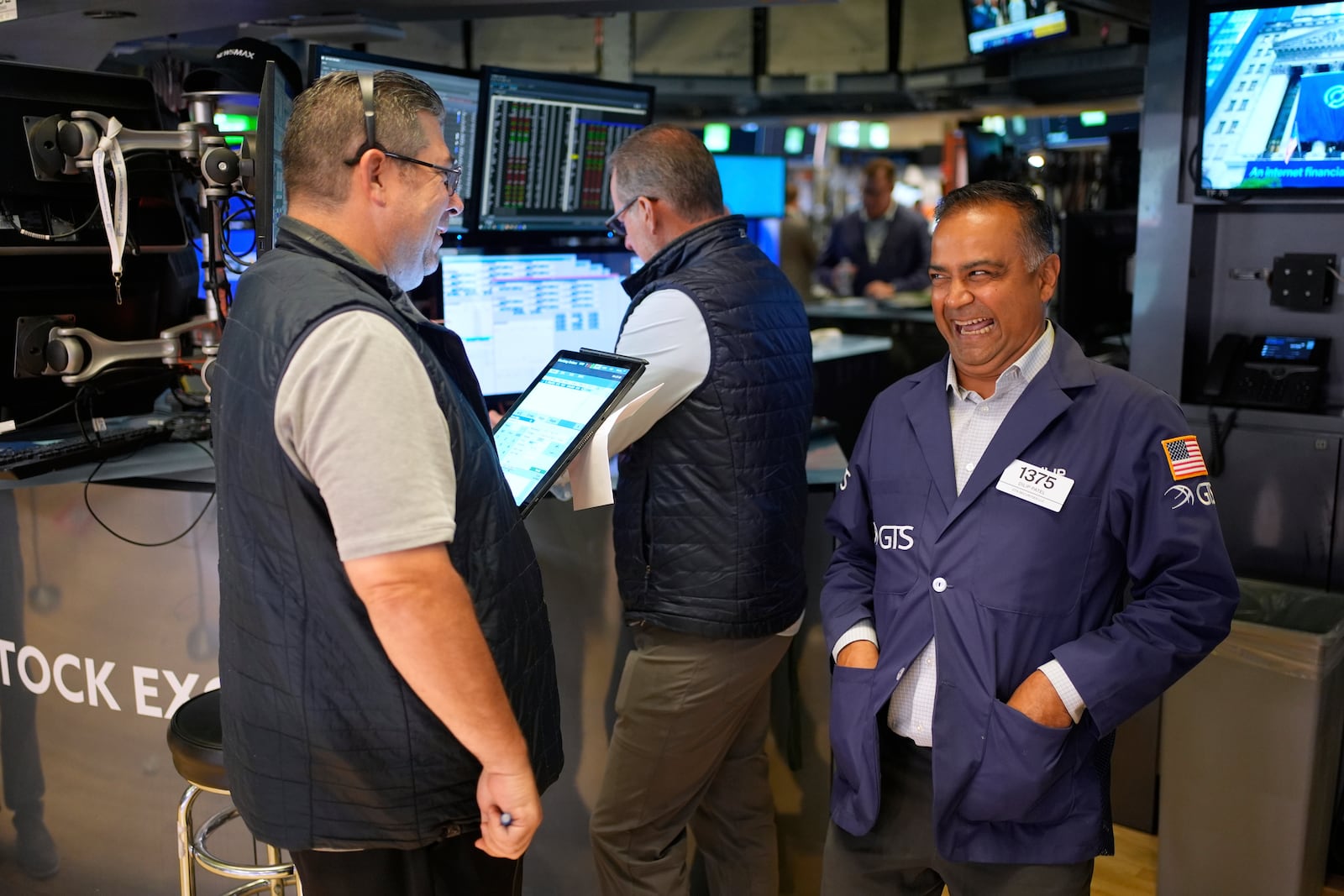 Dilip Patel laughs while working on the floor at the New York Stock Exchange in New York, Monday, July 14, 2025. (AP Photo/Seth Wenig)