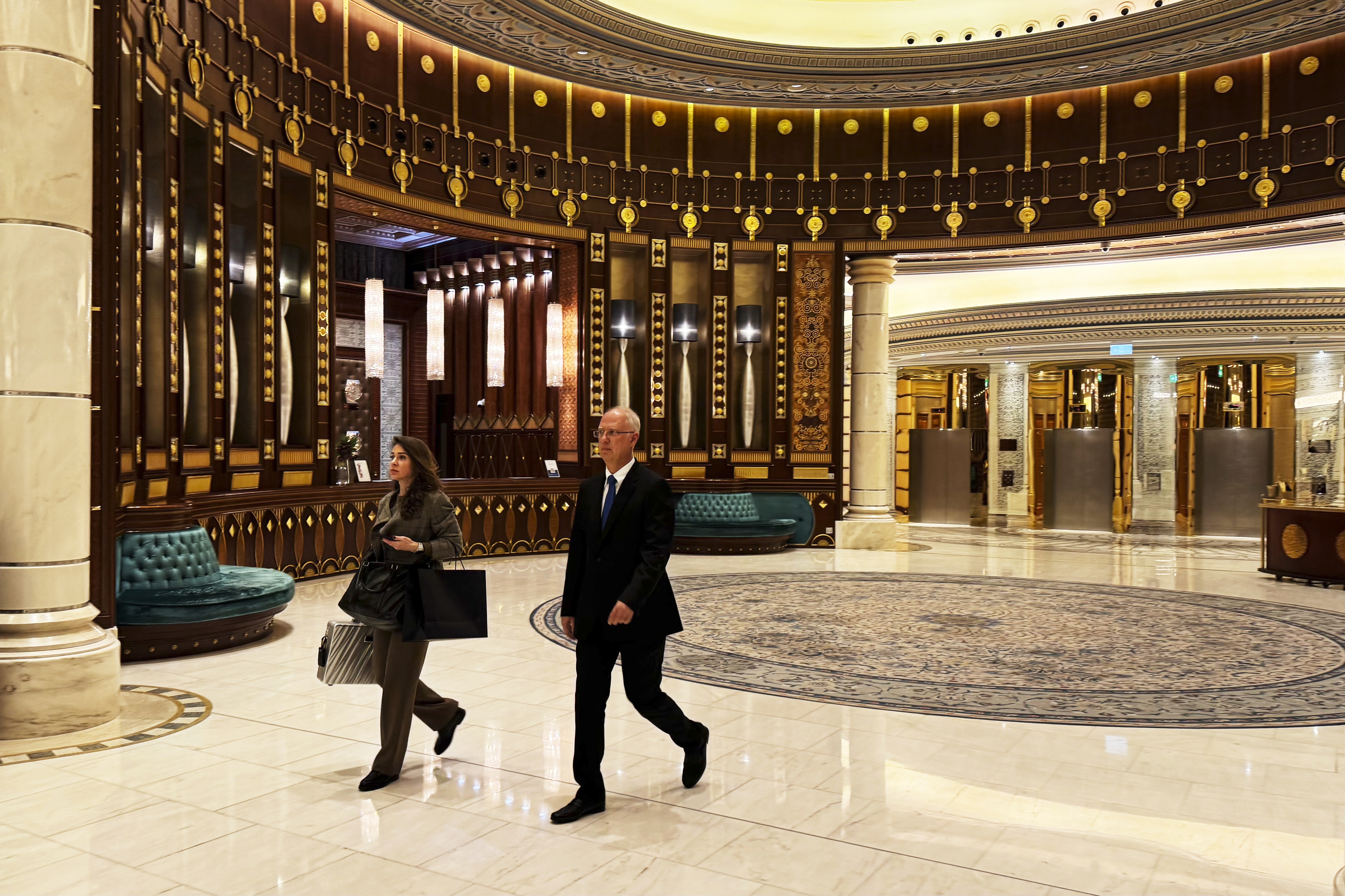 Kirill Dmitriev, the head of the Russian Direct Investment Fund, right, and Maria Medvedeva, the deputy CEO for external communication for the fund, walk across the Ritz Carlton hotel in Riyadh, Saudi Arabia, Tuesday, Feb. 18, 2025. (AP Photo/Baraa Anwer)