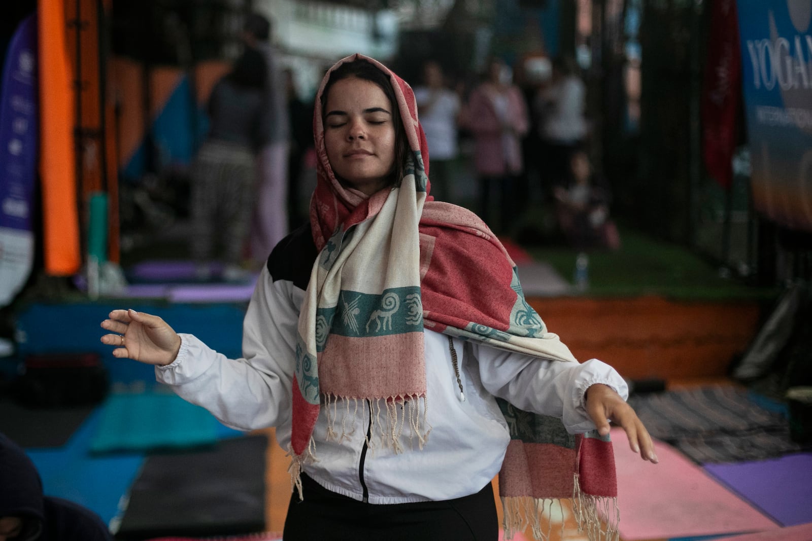 A woman dances during a performance by American vocalist of Hindu devotional music Jeff Kagel during a Transformation Project yoga class in the Rocinha favela in Rio de Janeiro, Wednesday, July 9, 2025. (AP Photo/Bruna Prado)