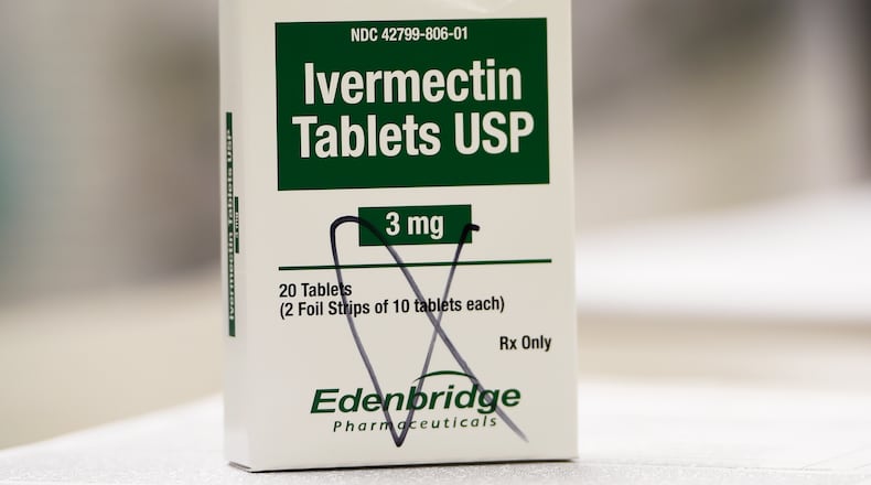 A box of ivermectin is shown in a pharmacy as pharmacists work in the background, Thursday, Sept. 9, 2021, in Ga. (AP Photo/Mike Stewart, File)