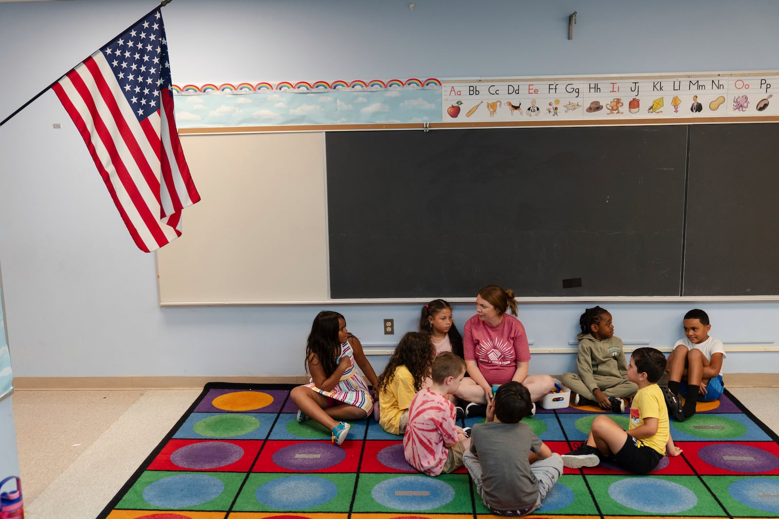 Jillian Murphy leads children in math activities during the East Providence Boys and Girls Club Summer Camp at Emma G. Whiteknact Elementary School on Thursday, July 10, 2025, in Providence R.I. (AP Photo/Sophie Park)
