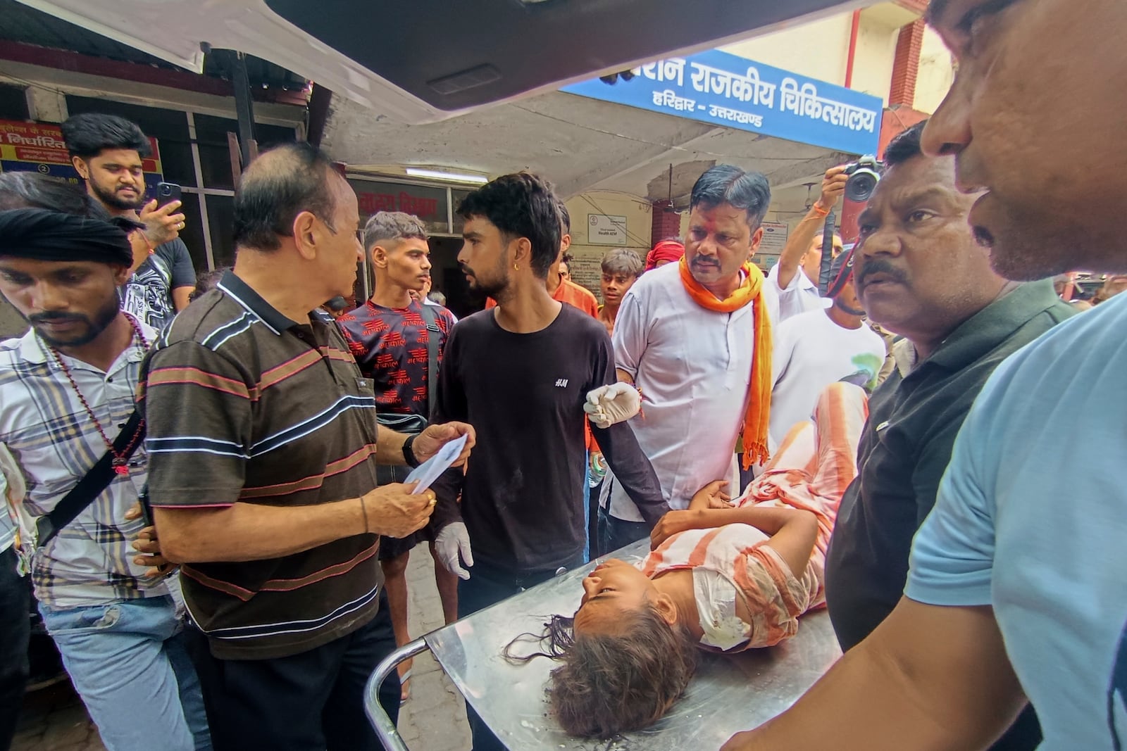 An injured from temple stampede is carried inside a hospital in Haridwar, India, Sunday, July 27, 2025. (AP Photo)