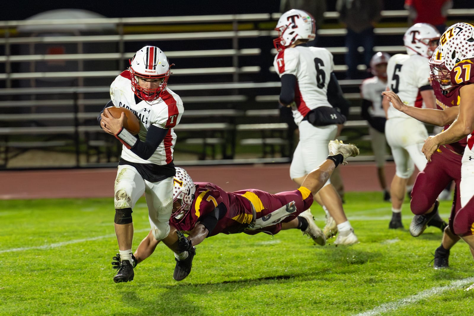 Triad High School freshman quarterback Ty Botkins runs past Northeastern senior Jackson Jones during their game on Friday, Oct. 24 at Conover Stadium. The Jets won 42-0 and clinched a share of the OHC North title with the victory. RODNEY GETZ / CONTRIBUTED PHOTO