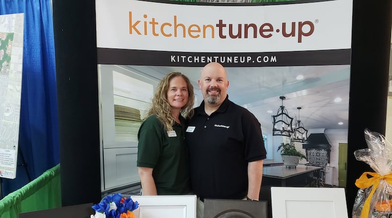 Laura and Matt Fields, of Liberty Twp., stand at the booth for their new Kitchen Tune-Up franchise at the West Chester/Liberty Chamber Alliance’s Regional Business Expo at Lakota West High School July 30, 2019. ERIC SCHWARTZBERG/STAFF