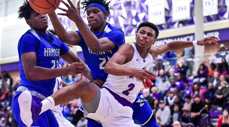 Middletown’s Shandon Morris (2) and Hamilton’s D’Marco Howard (25) and Romello Diablo (23) battle for a rebound during their game Dec. 7 at Wade E. Miller Arena in Middletown. The host Middies won 64-56. NICK GRAHAM/STAFF