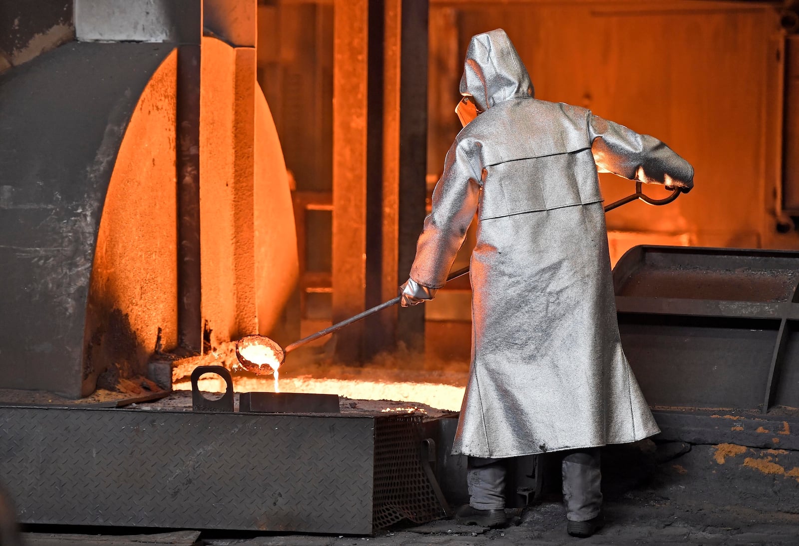FILE - A handles molten metal at the Thyssenkrupp steel factory in Duisburg, Germany, April 27, 2018. (AP Photo/Martin Meissner, File)