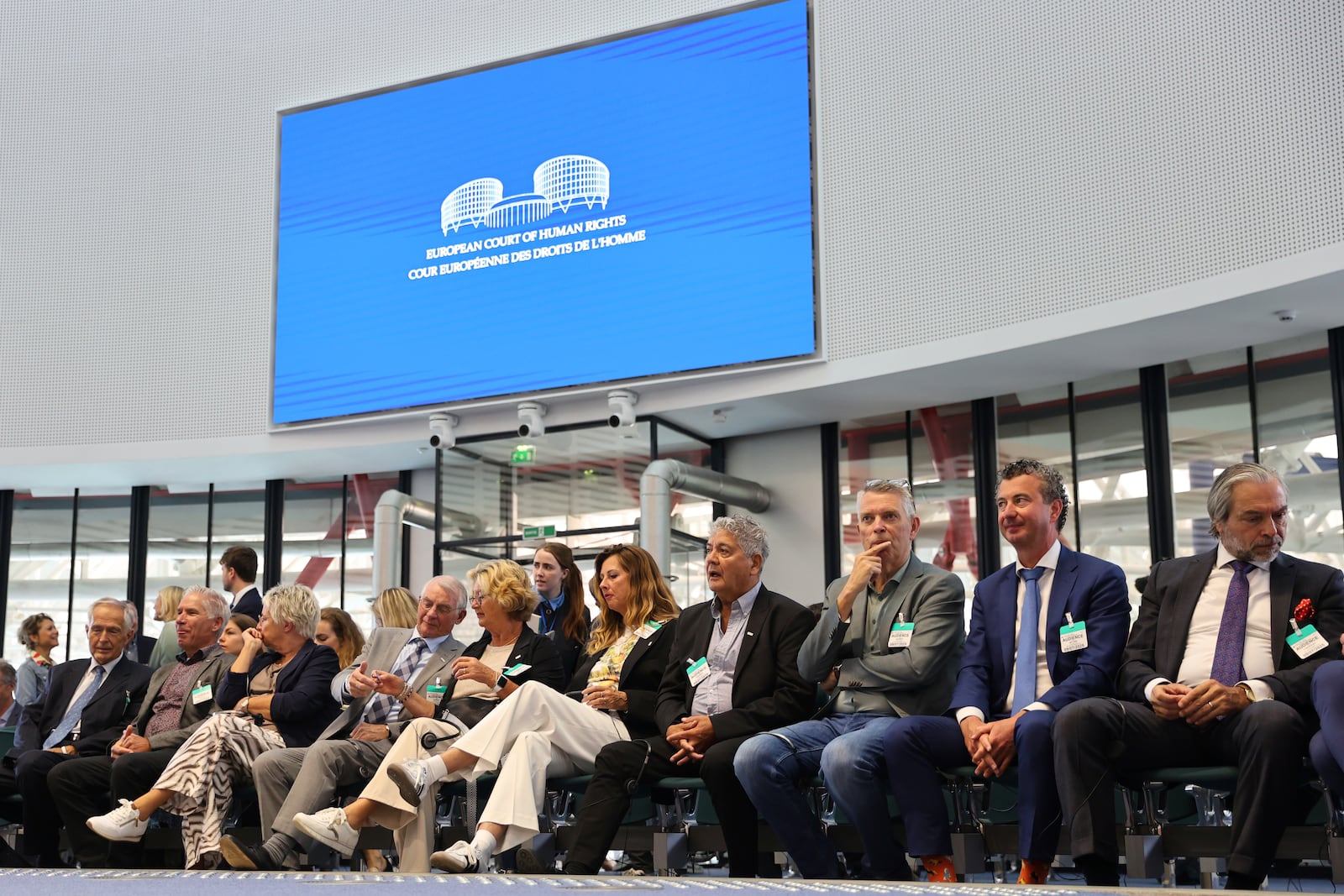 Plaintiffs sit in the European Court of Human Rights before it issues a landmark set of rulings about alleged Russian violations in Ukraine since 2014, including the downing of Malaysia Airlines flight MH17, Wednesday, July 9, 2025 in Strasbourg, eastern France. (AP Photo/Antonin Utz)