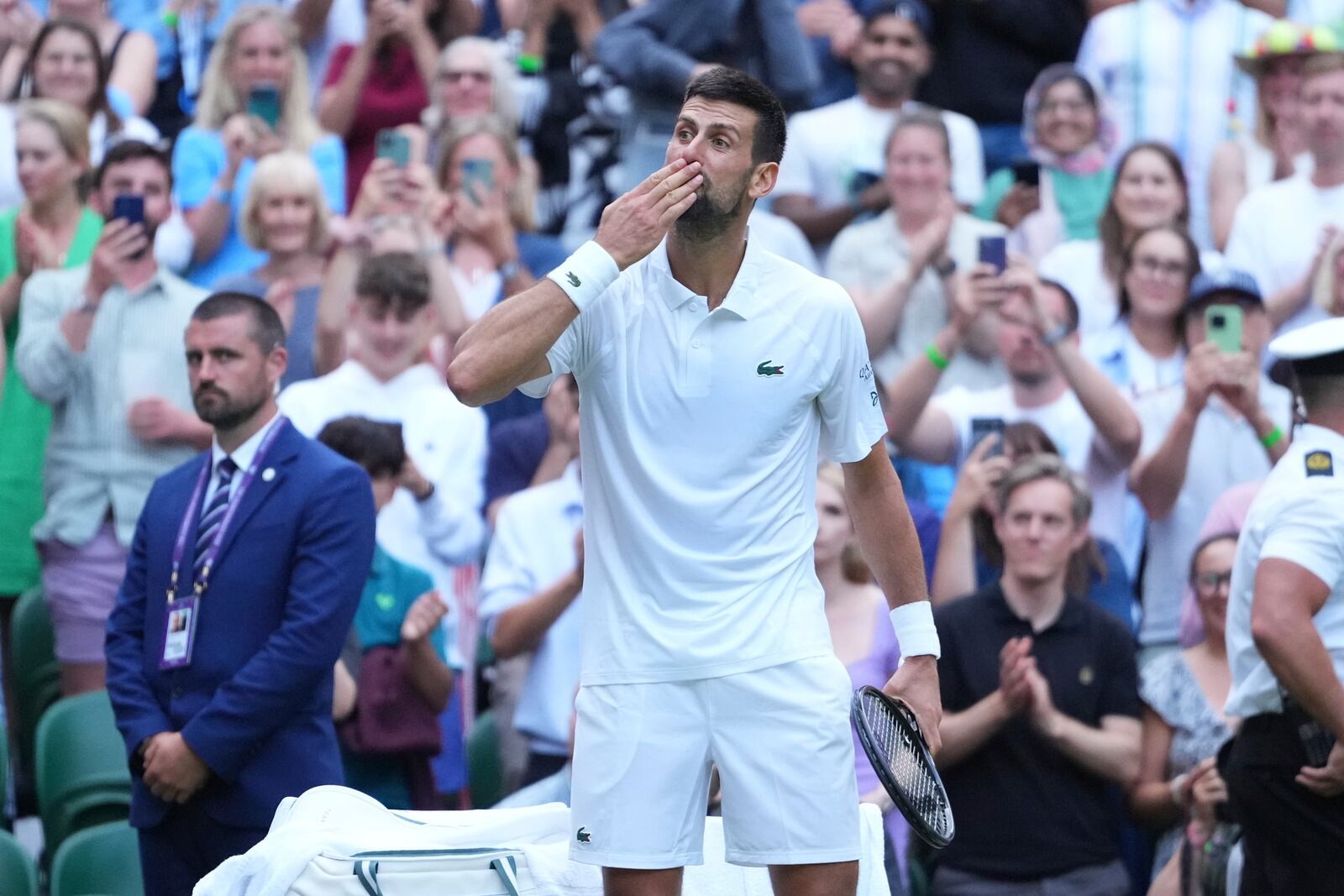 Novak Djokovic of Serbia blows a kiss as he celebrates beating Miomir Kecmanovic of Serbia during a third round men's singles match at the Wimbledon Tennis Championships in London, Saturday, July 5, 2025. (AP Photo/Kirsty Wigglesworth)