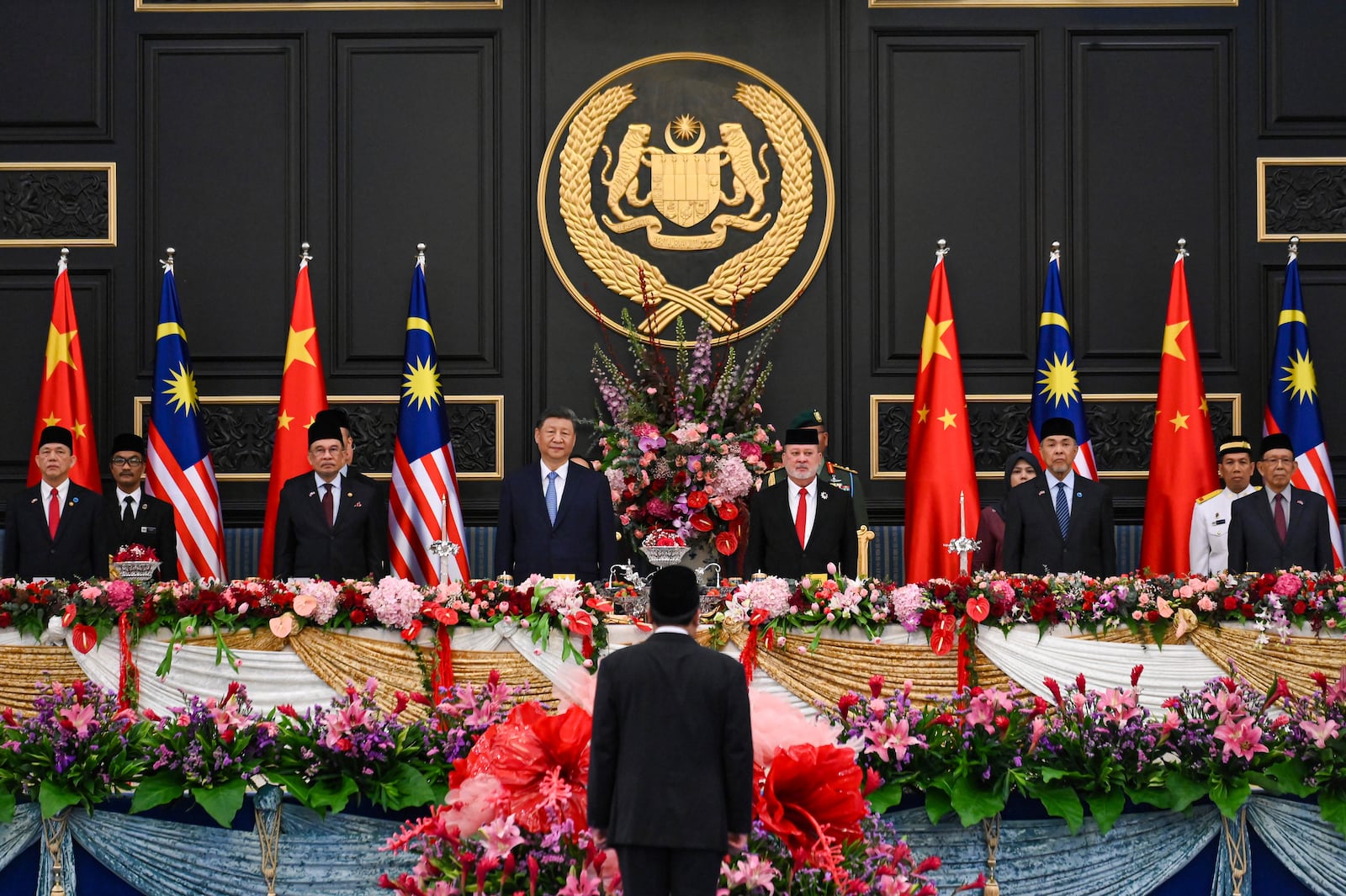 In this photo released by Malaysia's Department of Information, Malaysia's King Sultan Ibrahim, center right, and China's President Xi Jinping, center left, stand during their meeting at the National Palace in Kuala Lumpur, Malaysia Wednesday, April 16, 2025. (Famer Roheni/ Malaysia's Department of Information via AP)