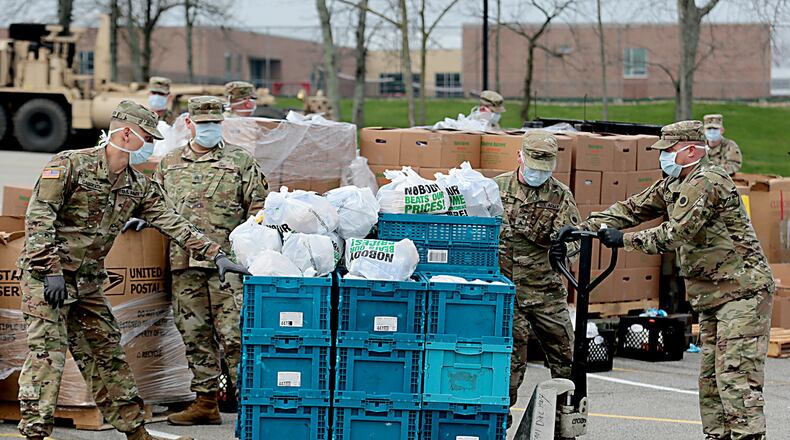 Shared Harvest Foodbank distributed emergency food boxes to more than 1,500 families on Saturday, May 2, 2020, at Fairfield High School. Pictured is the April distribution at the high school where around 60 Ohio National Guard and Army Reserve members assisted Saturday with 20 foodbank staff and volunteers. PROVIDED (E.L. HUBBARD/SHARED HARVEST FOODBANK)