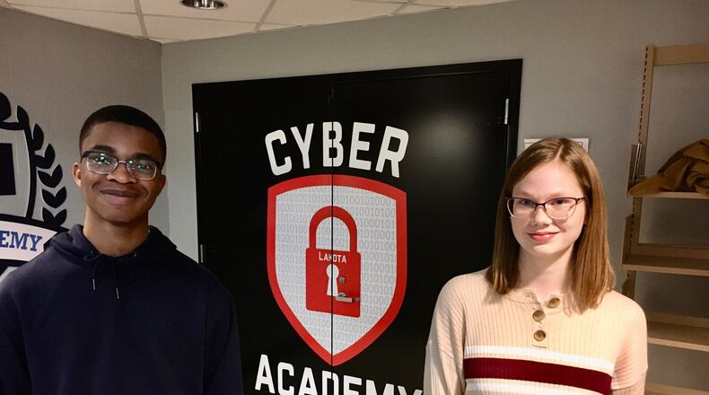 Lakota East High School students Joshua Alonge and Addy Price are two members of Lakota Schools’ new Cyber Academy designed to teach the computer skills necessary to prepare teens for internships in the booming cyber security industry. The academy holds classes at both Lakota East and Lakota West High School in the Butler County district. (Photo By Michael D. Clark/Journal-News)