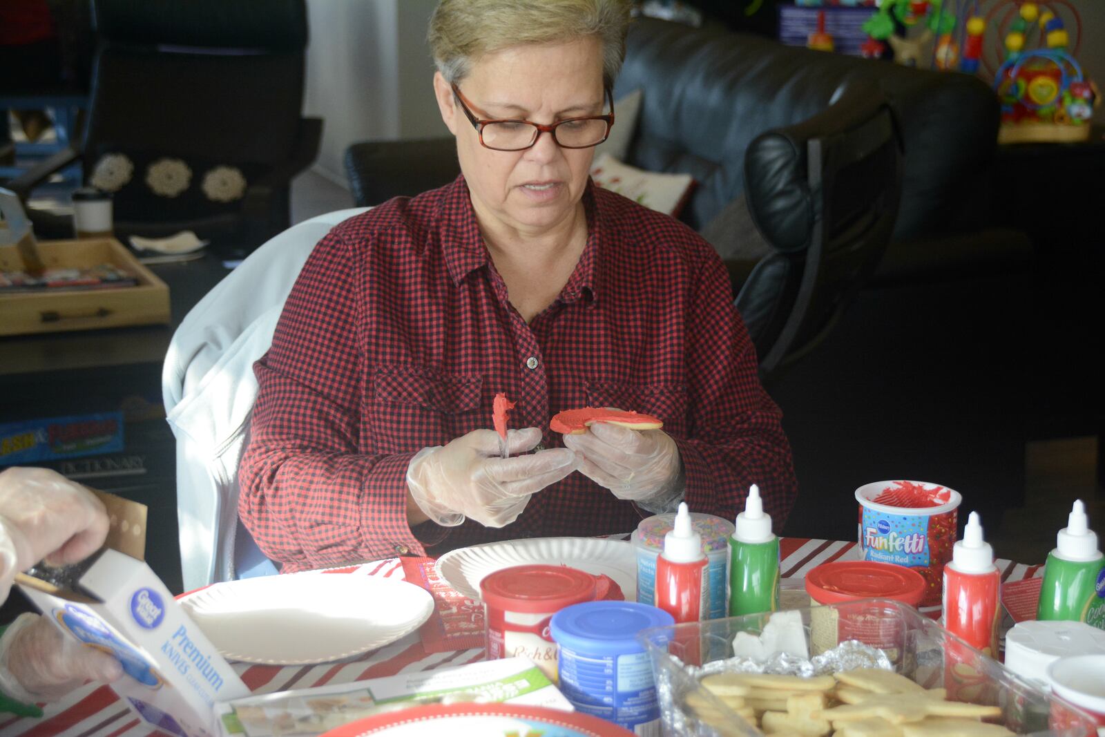 Coffee Cup Overflowing in Fairfield Twp. is more than just a coffee shop. Many groups, such as a group of women who decorated holiday and Christmas cookies for area first responders, use the space to meet. MICHAEL D. PITMAN/STAFF