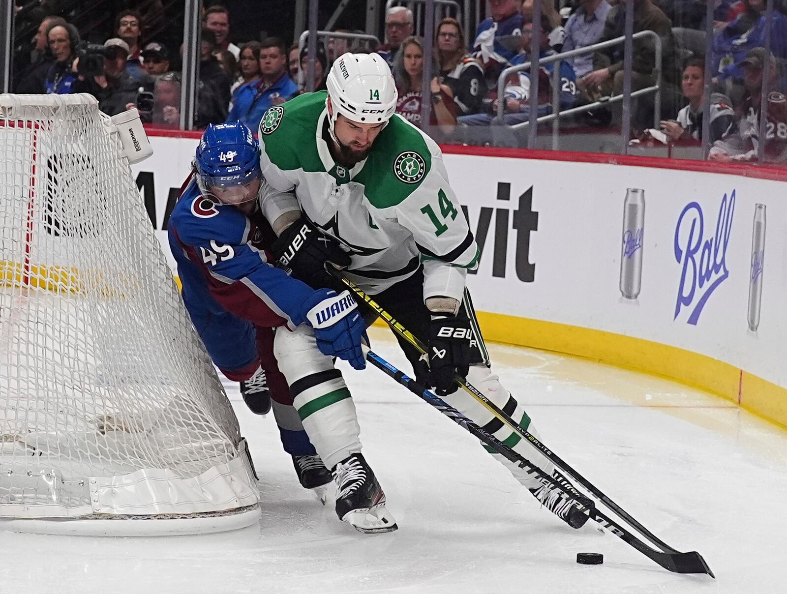 Dallas Stars left wing Jamie Benn, right, tries to wrap around the net as Colorado Avalanche defenseman Samuel Girard covers in the second period of Game 3 of an NHL hockey first-round playoff series Wednesday, April 23, 2025, in Denver. (AP Photo/David Zalubowski)