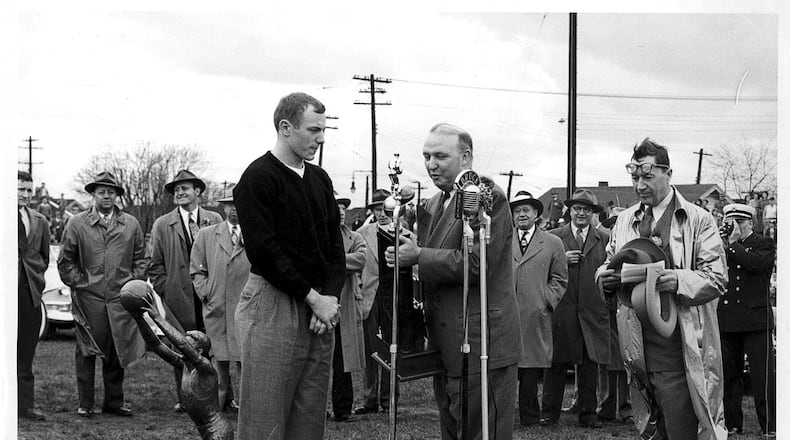 March 28, 1949 - Gene Baldwin, Captain of the 1949 State Basketball Champions, is presenting the state championship trophie to Hamilton City Schools Superintendent Walton Crewson. The presentation took place at the football athletic field on Fair Ave. & Dayton St. Others in the picture are Ed Griesinger, Booster President, Byron Hollinger, Reserve Basketball Coach and Mr. J. O. Fry, Hamilton High School Principal. (Behind Mr. Crewson) The photo is courtesy of Bernie Griesinger.