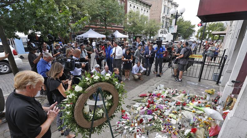 Media workers gathered around the entrance to Ned Peppers in the Oregon District for a press conference with Dayton Mayor Nan Whaley last week. Whaley is proposing a permanent memorial for the victims of the mass shooting Aug. 4. TY GREENLEES / STAFF