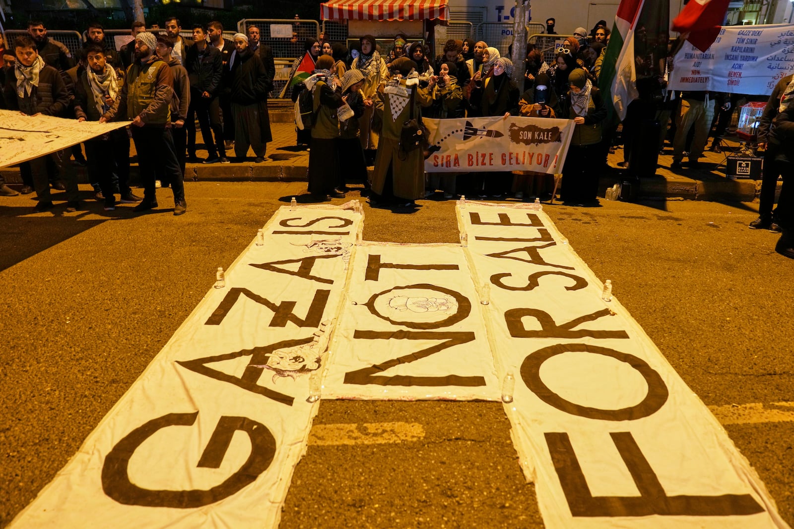 People protest against an Israeli drone attack on a vessel carrying aid to Gaza in international waters off Malta, outside the Israeli consulate in Istanbul, Friday, May 2, 2025. (AP Photo/Khalil Hamra)
