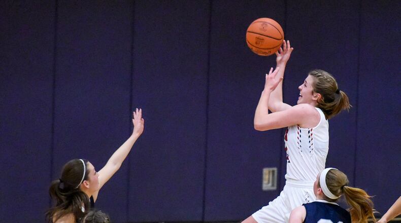 Talawanda’s Emma Wright drives to the hoop between Edgewood defenders Tori Childers (left) and Cierra Lipps (21) during Wednesday night’s game in Oxford. Visiting EHS won 31-28. NICK GRAHAM/STAFF