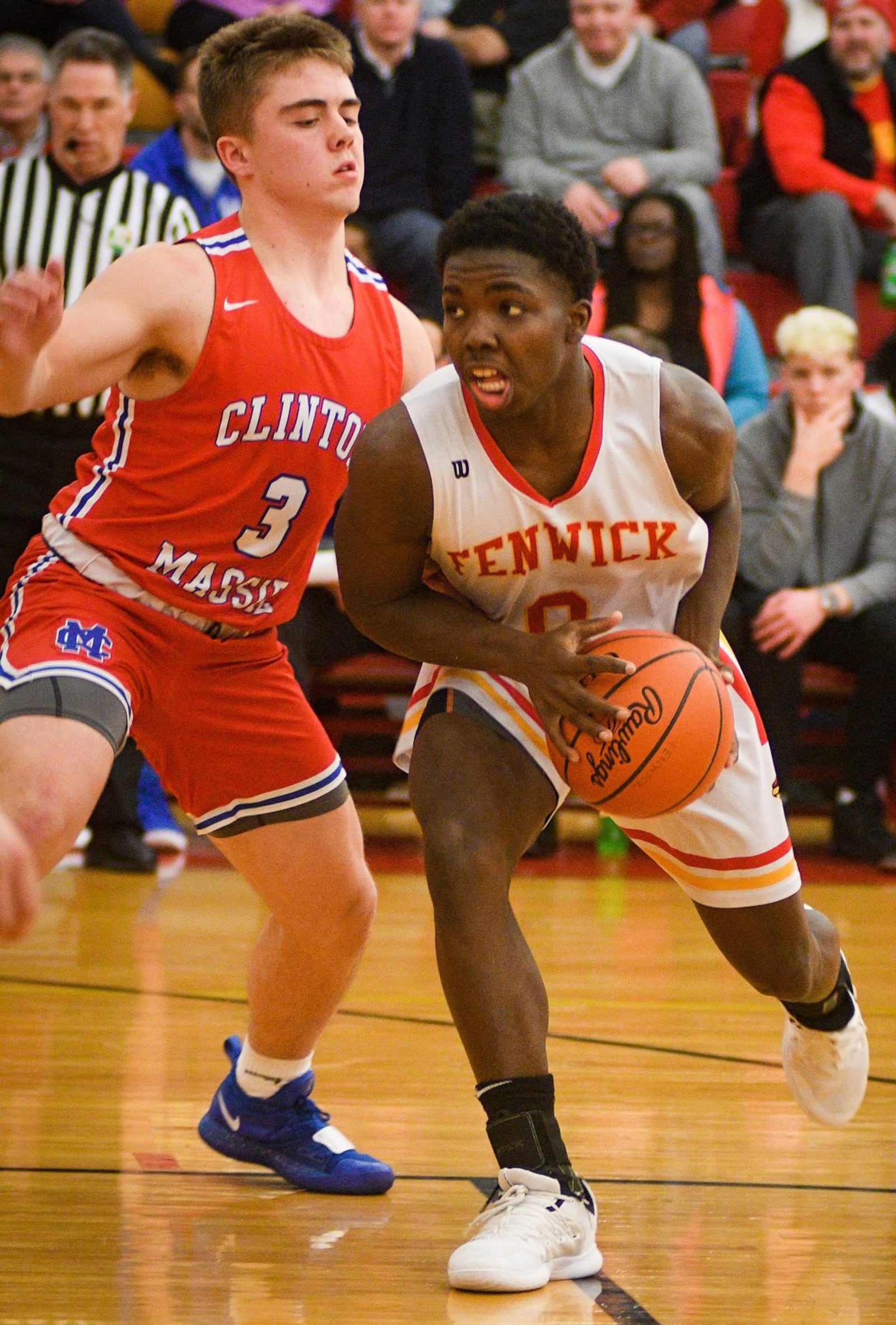 Fenwick’s Caleb Davis (0) tries to drive past Clinton-Massie’s Brendan Lamb (3) during Monday night’s game at Fenwick. The host Falcons won 67-48. ROB MCCULLEY/RAM PHOTOGRAPHY