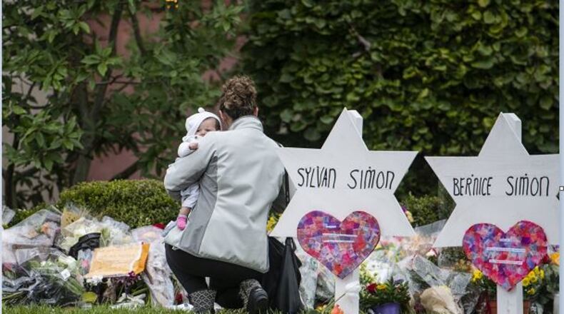 Mourners visit a makeshift memorial outside the Tree of Life Congregation, where 11 people died at the synagogue during a shooting rampage, in Pittsburgh, Oct. 29, 2018. Survivors and relatives of the victims were still struggling to come to terms with the enormity of the loss as the suspect prepared to face court for the first time on Monday. (Michael Henninger/The New York Times)