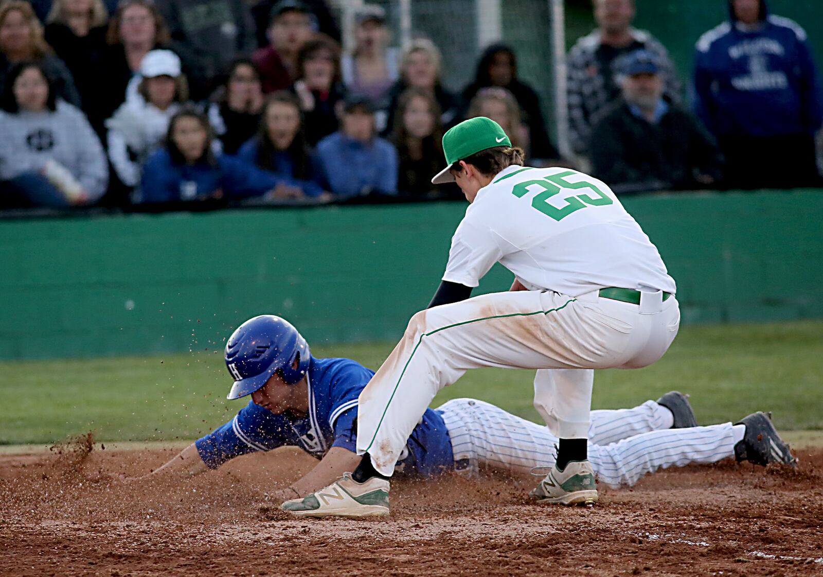 Hamilton’s Reid Ruhl slides under the tag of Badin pitcher Devon Valentino during Saturday night’s game at Alumni Field in Hamilton. CONTRIBUTED PHOTO BY E.L. HUBBARD