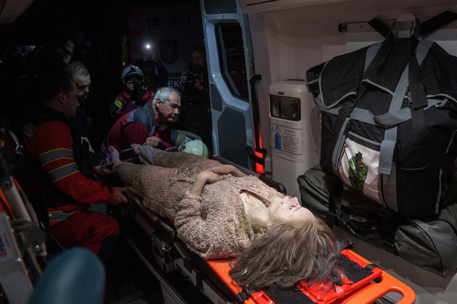Medics tend to an injured woman in an ambulance near a house destroyed by a Russian airstrike in a residential neighbourhood in Kyiv, Ukraine, on Thursday, April 24, 2025. (AP Photo/Evgeniy Maloletka)