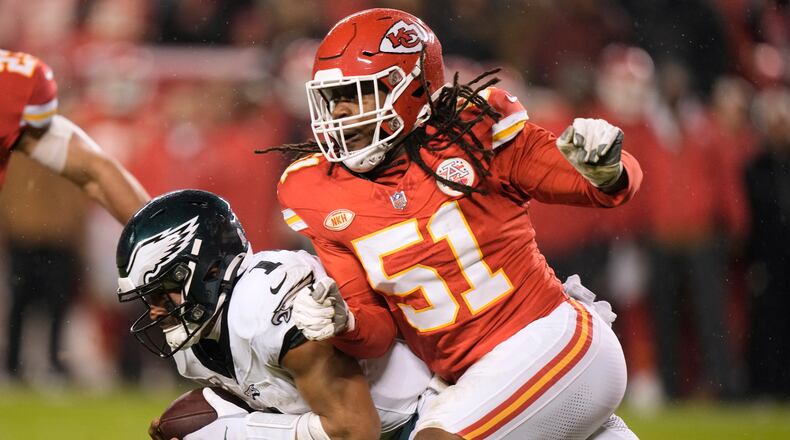Philadelphia Eagles quarterback Jalen Hurts (1) runs with the ball as Kansas City Chiefs defensive end Mike Danna (51) defends during the second half of an NFL football game, Monday, Nov. 20, 2023, in Kansas City, Mo. (AP Photo/Charlie Riedel)