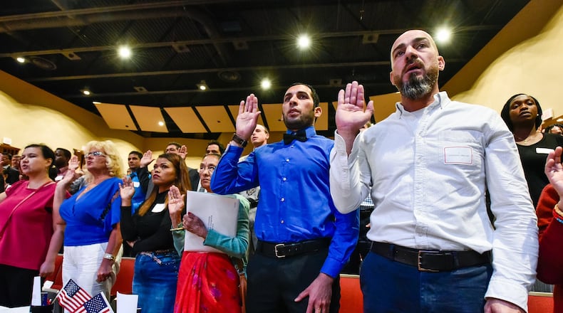 Abbas MR Almukahal, right, from Palestine, and Abbas Musafer Ajmi Jasmie, from Iraq, were among the 99 people who became U.S. citizens during a naturalization ceremony Monday, Sept. 17 at Miami University Hamilton’s Parrish Auditorium in Hamilton.
