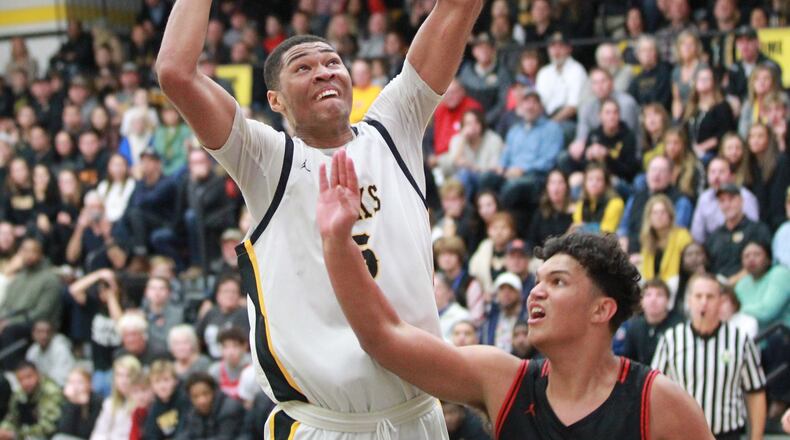 Mo Njie of Centerville elivates over Elijah Brown of Wayne. Wayne defeated host Centerville 52-50 in a GWOC boys high school basketball game on Friday, Dec. 13, 2019. MARC PENDLETON / STAFF