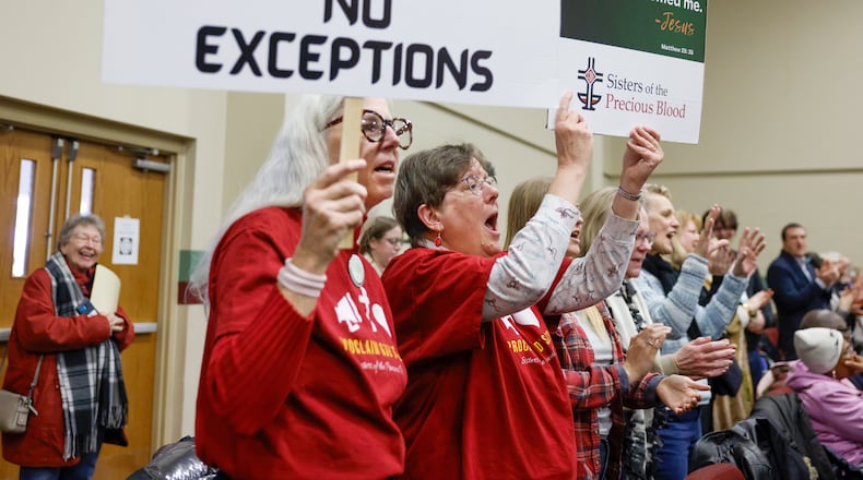 Audience members sing along to praise songs and hold pro-immigration signs during Here We Stand: Faith Leaders for Immigration Justice & Family Unity at St. John Missionary Baptist Church on Monday, Feb. 2, 2026, in Springfield. Pastors, faith leaders and community members gathered to pray and call for the extension of Temporary Protected Status which is scheduled to expire on Tuesday, Feb. 3, 2026. JOSEPH COOKE/STAFF