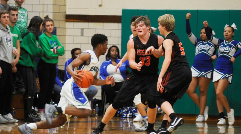 Chaminade Julienne’s Milton Gage (with ball) drives on A.J. Ahrens and Michael Stammen of Versailles in a game Dec. 12, 2017, at CJ. The visiting Tigers won 68-40. MARC PENDLETON/STAFF