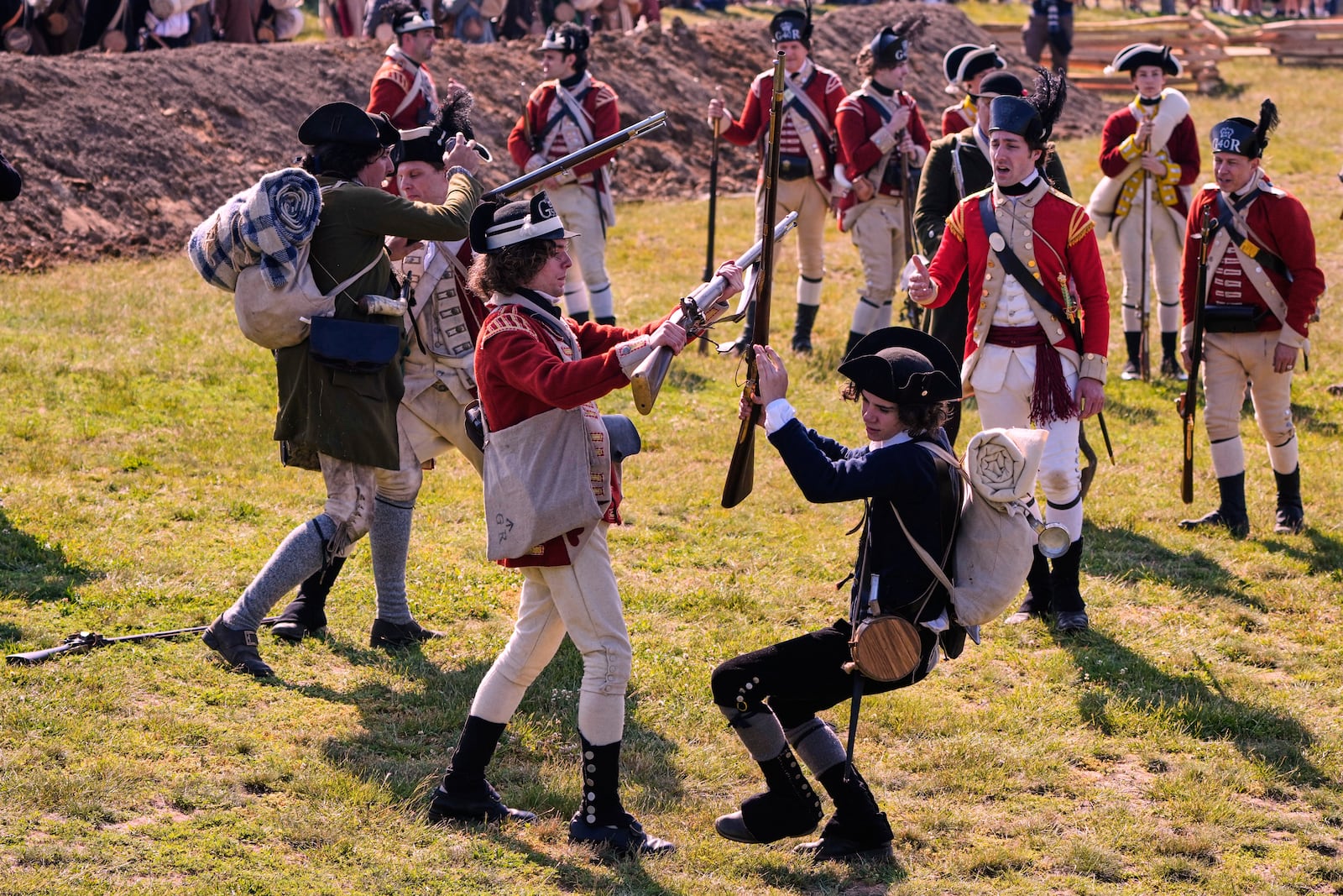 British and Colonial soldiers engage during a reenactment in celebration of the 250th anniversary of the Battle of Bunker Hill, Saturday, June 21, 2025, in Gloucester, Mass. (AP Photo/Charles Krupa)