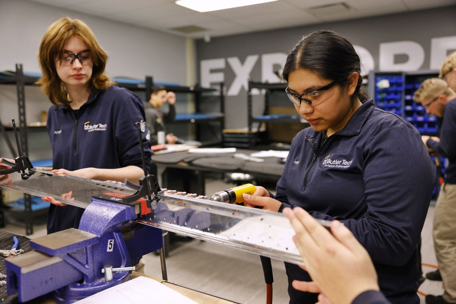 Seniors Karsen Power, left, and Dominga Lorenzo-Perez work on constructing a section of an airplane during their aviation class at Butler Tech Wednesday, March 26, 2025 in Farifield Township. Students are building an airplane with parts an build plans supplied by Tango Flight. NICK GRAHAM/STAFF
