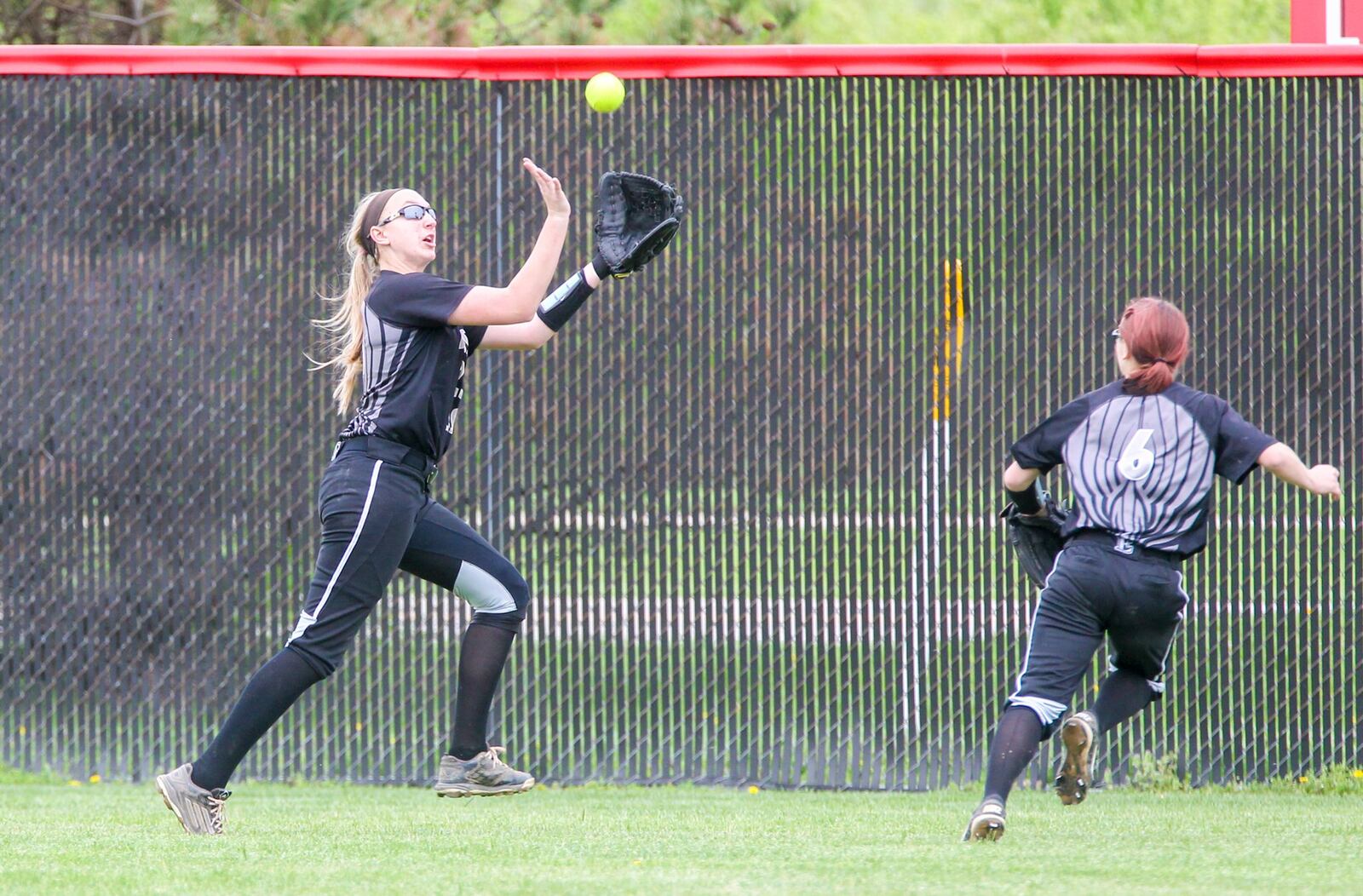 Lakota East center fielder Regan Butikofer (23) tracks down a fly ball during their game at Lakota West on Tuesday. GREG LYNCH/STAFF