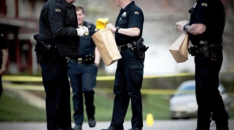 Dayton police mark where bullet casings were found. STAFF