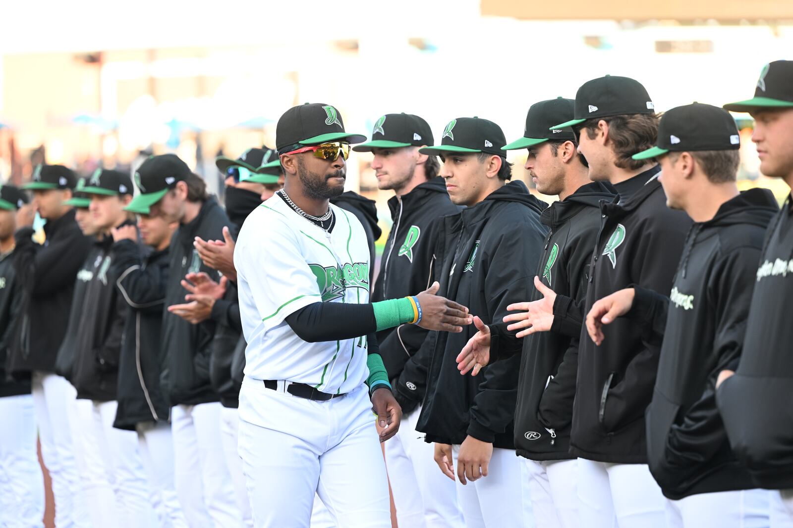 Myles Smith, of the Dayton Dragons, slaps hands with teammates after being introduced before a game at Day Air Ballpark on April 8, 2025. Photo courtesy of Dragons
