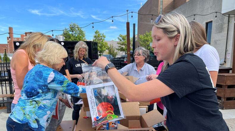The Books and Brews event, where literacy kits will be assembled to support young children, is set for 4 to 6 p.m. Thursday, Sept. 5, at Pour House, 138 Riverfront Plaza, downtown Hamilton. Pictured is a previous time volunteers assempled literacy kits, but at Municipal Brew Works in downtown Hamilton. PROVIDED/BUTLER COUNTY UNITED WAY