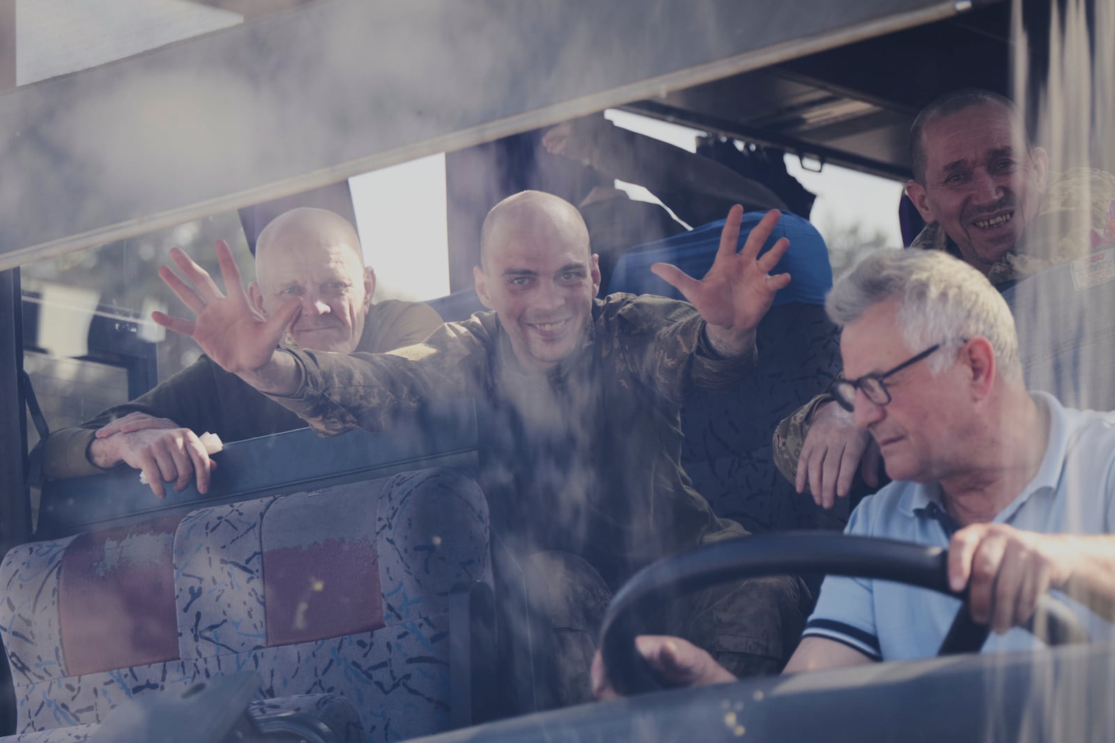 In this photo provided by the Ukrainian Presidential Press Office, Ukrainian servicemen ride in a bus after returning from captivity after an exchange between Russia and Ukraine, in Chernyhiv region, Ukraine, Friday, May 23, 2025. (Ukrainian Presidential Press Office via AP)
