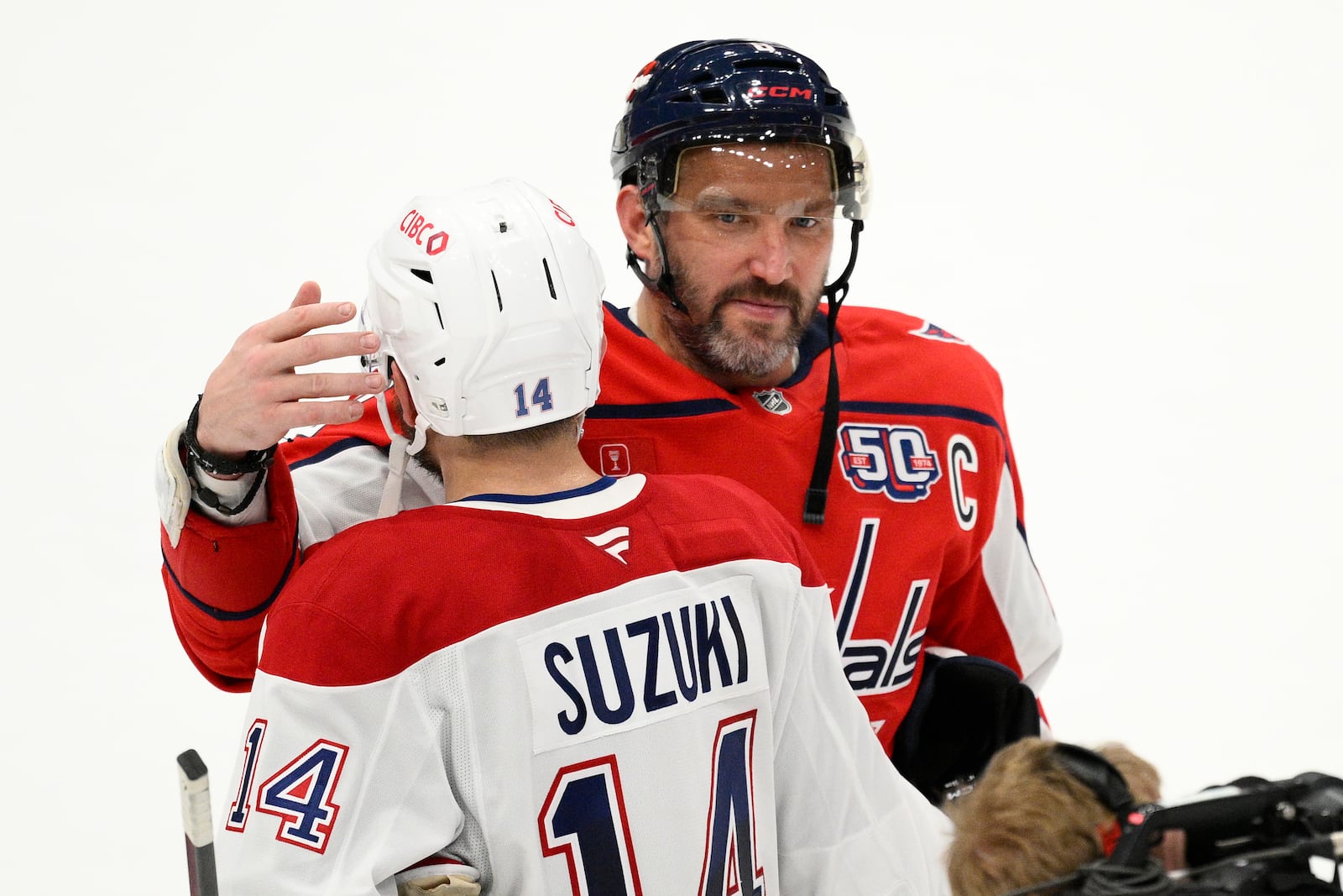 Washington Capitals left wing Alex Ovechkin (8) greets Montreal Canadiens center Nick Suzuki (14) after Game 5 of a first-round NHL hockey playoff series Wednesday, April 30, 2025, in Washington. (AP Photo/Nick Wass)