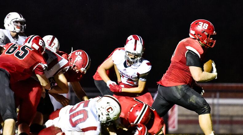 Madison’s Max Evans carries the ball in for a touchdown during the Mohawks’ 54-0 win over visiting Carlisle on Friday night at Brandenburg Field in Madison Township. NICK GRAHAM/STAFF