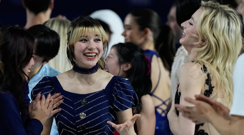 Alysa Liu of the United States, center, reacts with other athletes after performing in the figure skating exhibition at the 2026 Winter Olympics, in Milan, Italy, Saturday, Feb. 21, 2026. (AP Photo/Ashley Landis)