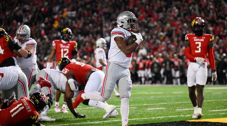Ohio State running back Dallan Hayden, center, scores a touchdown past Maryland defensive back Deonte Banks (3) and others during the second half of an NCAA college football game, Saturday, Nov. 19, 2022, in College Park, Md. Ohio State won 43-30. (AP Photo/Nick Wass)
