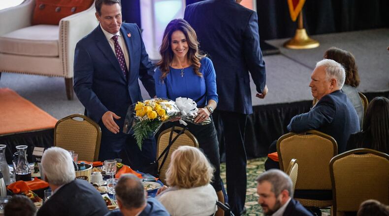 Ohio Lt. Gov. Jon. Husted and his wife, Tina Husted, presented Maureen Patterson with a bouquet of flowers on Wednesday Feb. 8, 2023 at the Dayton Development Coalition's annual meeting at Carillon Historical Park after Jon Husted received the Maureen Patterson Regional Leader Award. JIM NOELKER/STAFF