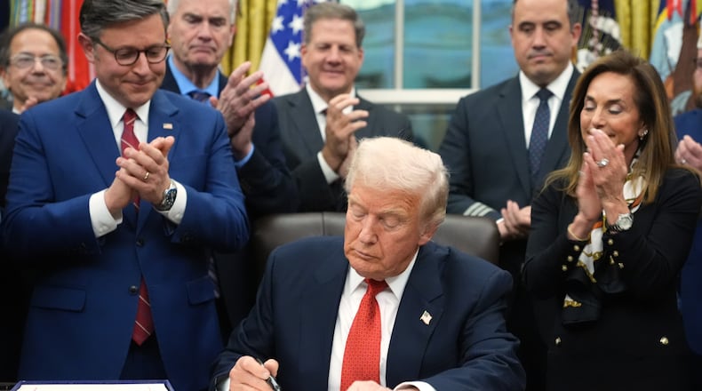 President Donald Trump signs the funding bill to reopen the government, in the Oval Office of the White House, Wednesday, Nov. 12, 2025, in Washington. (AP Photo/Jacquelyn Martin)