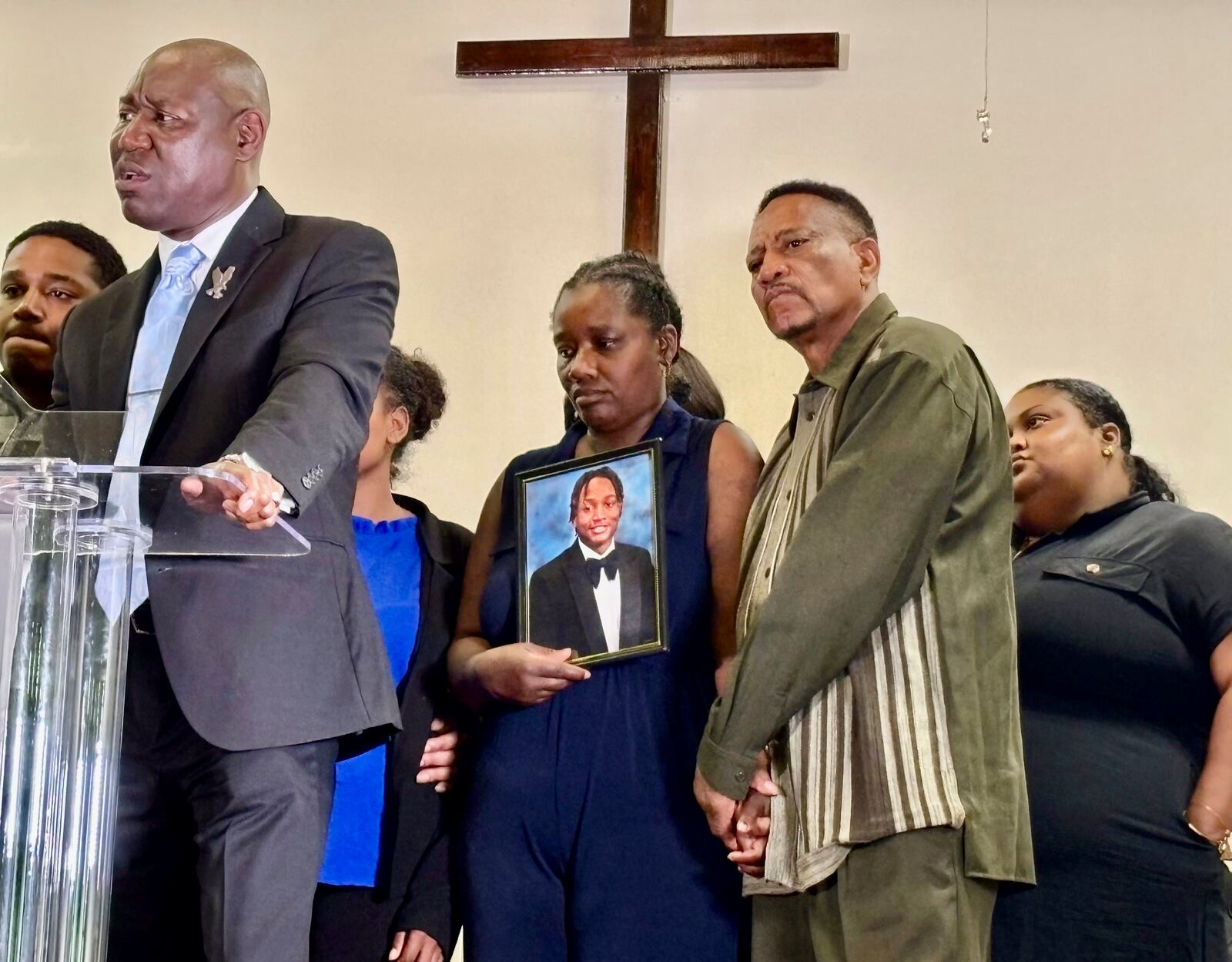 Vivian Sterling, center, and William Peoples stand with a photo of their son, Jabari Peoples, as attorney Ben Crump, far left, speaks to reporters during a press conference in Homewood, Ala., Tuesday, July 8, 2025. (AP Photo/Kim Chandler)