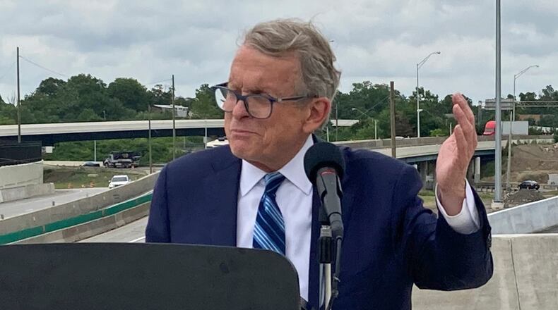 FILE - In this July 13, 2021 file photo, Ohio Gov. Mike DeWine promotes a new entrance ramp onto I-70 in Columbus, Ohio. A political stalemate over Ohio’s new legislative maps has plunged the state into confusion. As members of a new map-drawing commission defended themselves against potential contempt charges for failing to meet the latest court order requiring them to stop gerrymandering, top leaders were urging lawmakers to delay the May 3 primary. The bipartisan Ohio Redistricting Commission planned to meet again Wednesday, Feb. 23, 2022 and Thursday. (AP Photo/Andrew Welsh-Huggins, File)