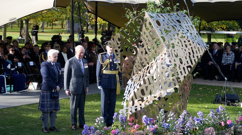 King Charles III stands during a visit to the National Memorial Arboretum in Alrewas, Staffordshire, for the dedication ceremony of the LGBT+ Armed Forces memorial, the UK's first national memorial commemorating LGBT+ people who have served and continue to serve in the military, Monday, Oct. 27, 2025. (Peter Byrne/PA via AP)